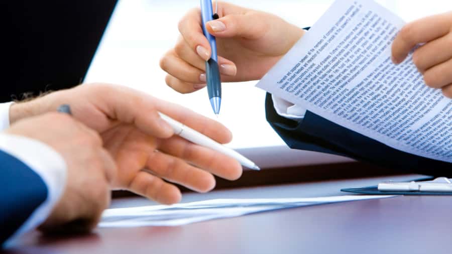 A private meeting room with a handshake between clients